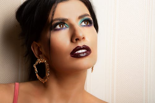 Free Woman With Dark Lipstick Wearing Earrings  Stock Photo