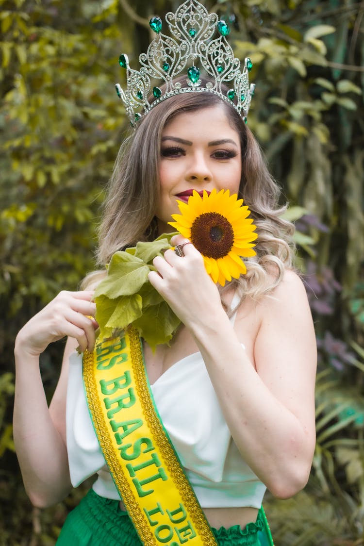 Woman Wearing Crown Holding A Sunflower