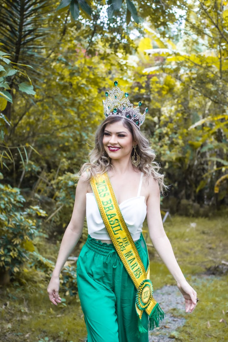 Beautiful Woman Wearing A Yellow Sash And Crown