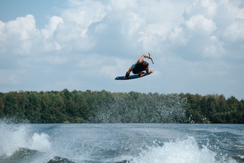 Man Riding a Wakeboard in Mid-Air