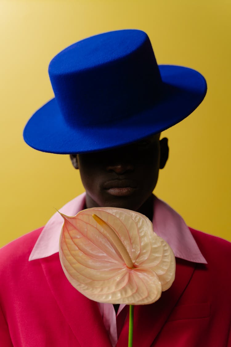 Man In Pink Blazer Wearing A Blue Velvet Hat 