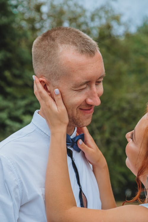 Woman Holding Man's Face