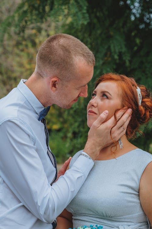 Free Man Touching and Looking at Woman's Face Stock Photo