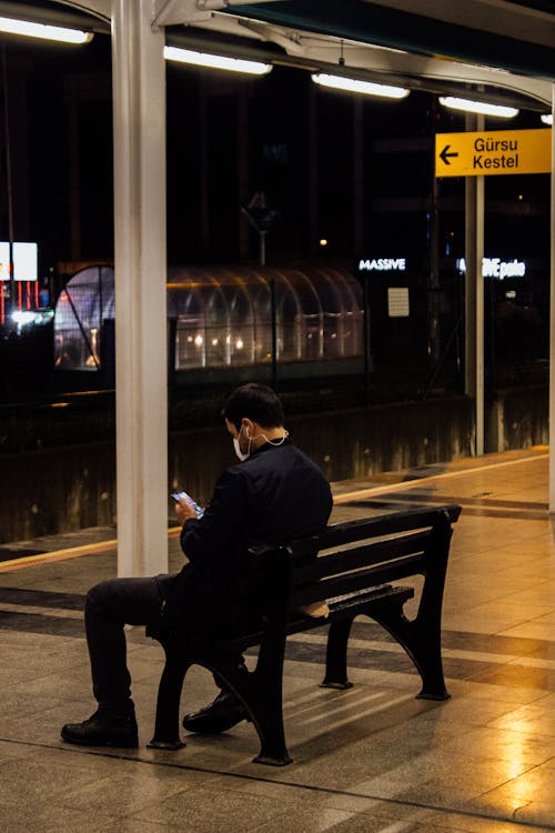 Man Sitting on a Bench Waiting for the Train