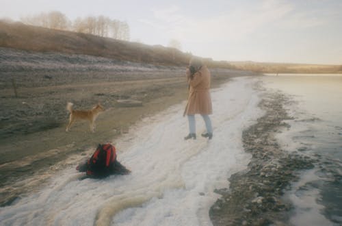 Woman Taking Photo of a Dog