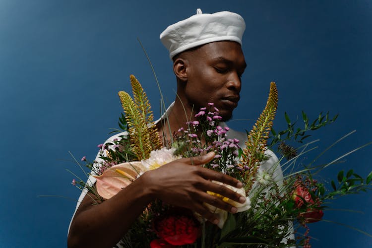 A Man Holding Bouquet Of Flowers