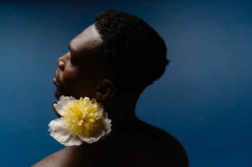 A Topless Man Holding Yellow Flower