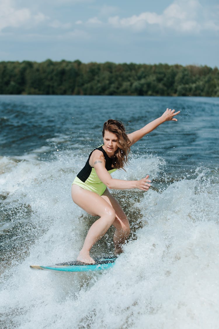 Woman Wakesurfing On Lake