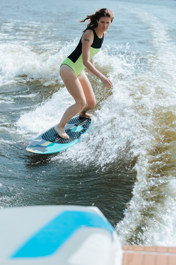 A Woman Surfing On The Beach