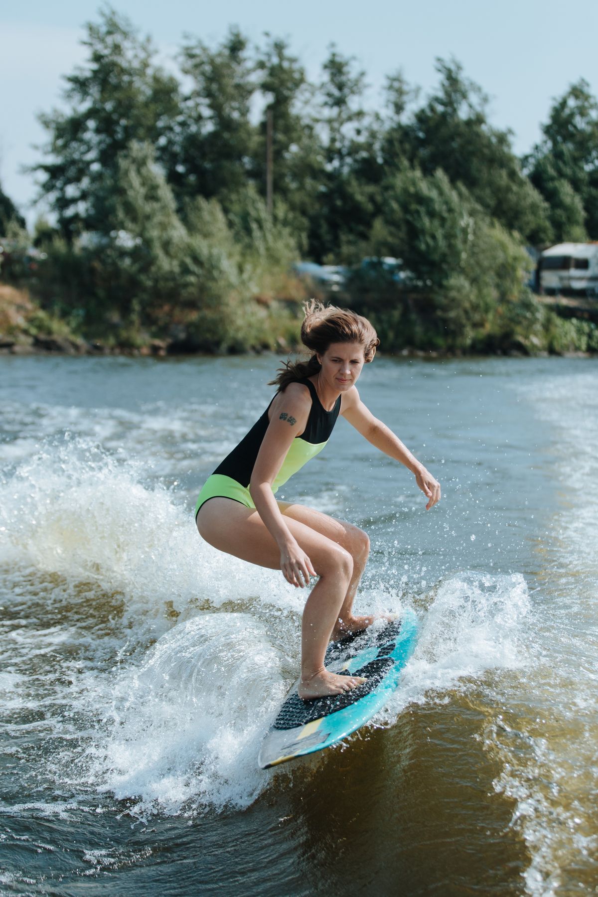 Wakesurfer riding the wake on a calm lake