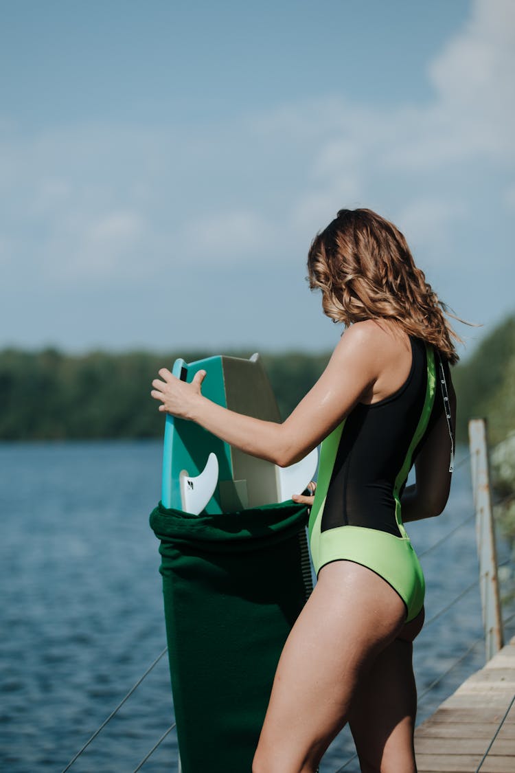 Woman Packing Wakesurf Board