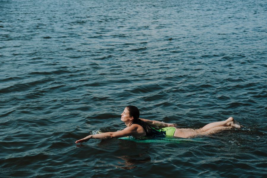 A swimmer moving through dark open water — photo by Ron Lach on Pexels