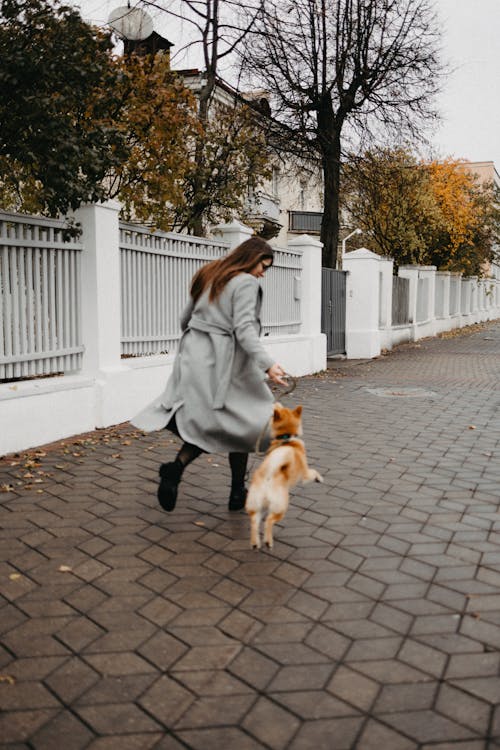 A Woman Running with Her Dog 
