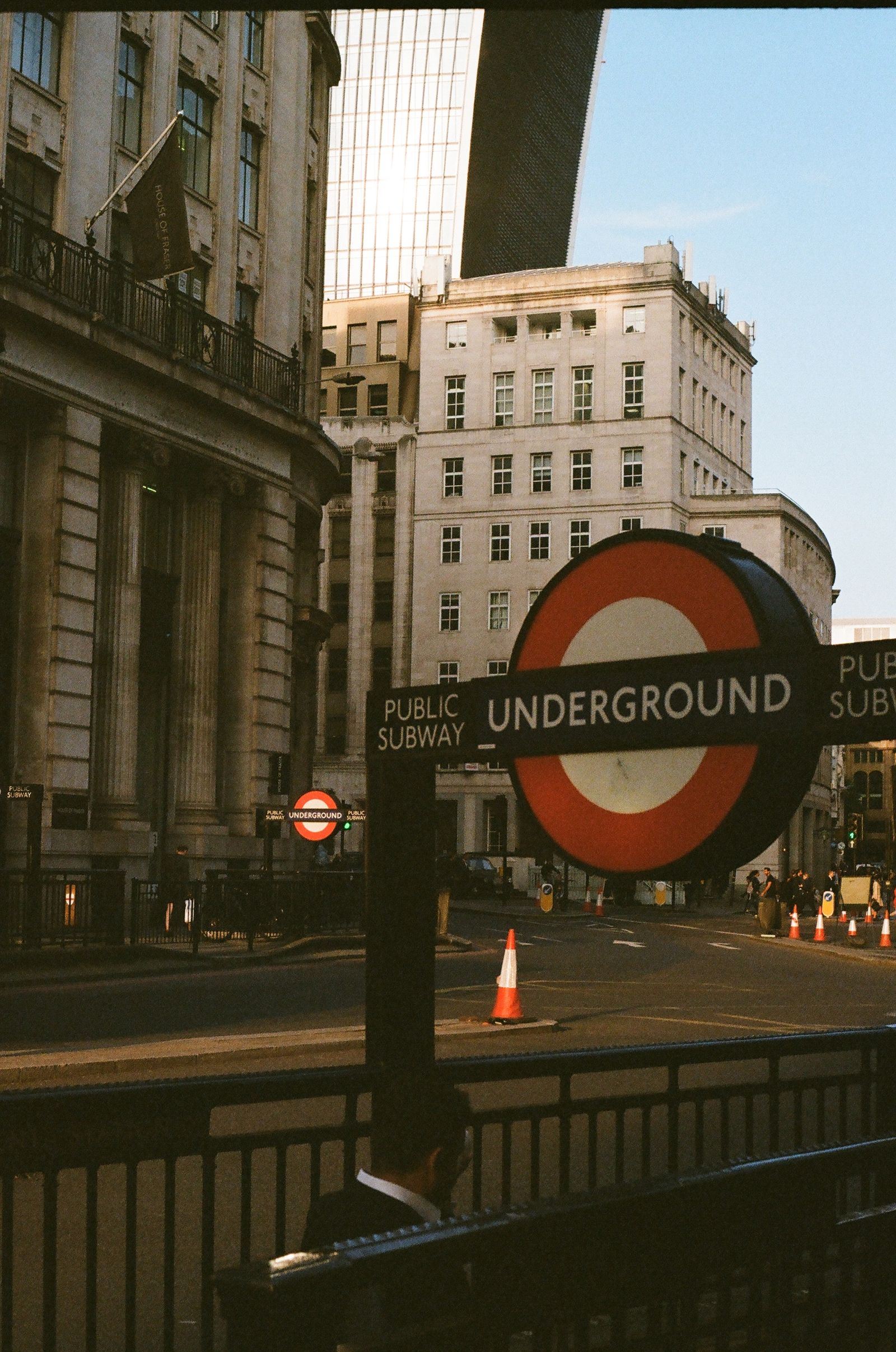 A London Underground station entrance with people passing by