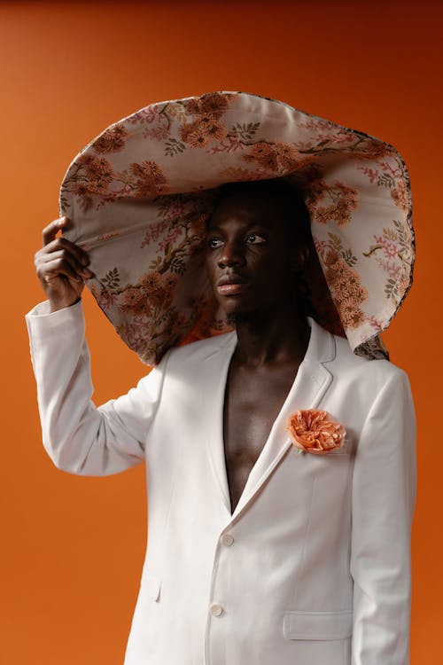 Man in White Blazer and Wide Floral Hat