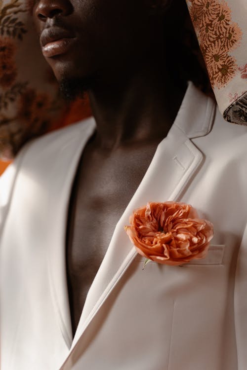 Orange Rose Boutonniere on White Suit Jacket