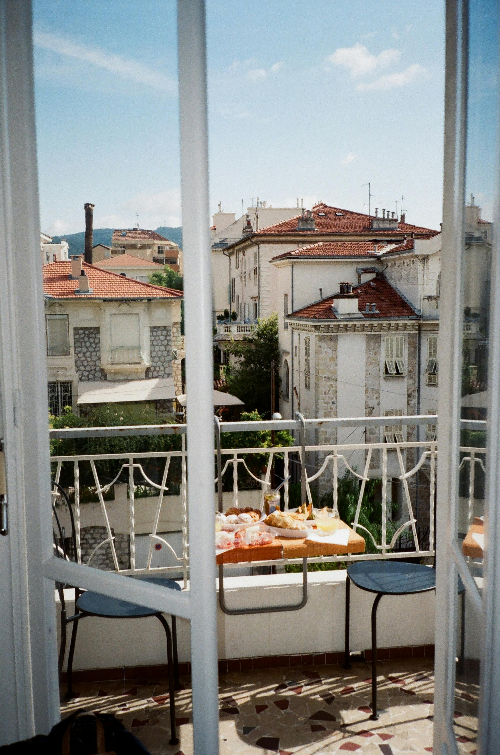 Enjoy a scenic breakfast with a view of Nice, France from a cozy balcony.