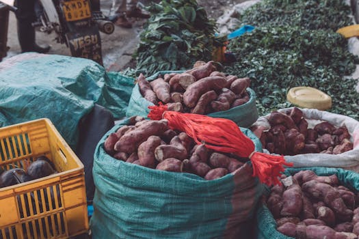 Vibrant street market in Ruaka, Kenya showcasing sweet potatoes and fresh vegetables.