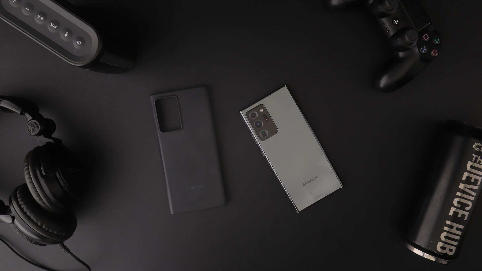 Phone and Other Devices on Black Table
