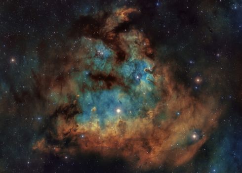A vivid cosmic nebula with vibrant colors and star field, showcasing the beauty of space.