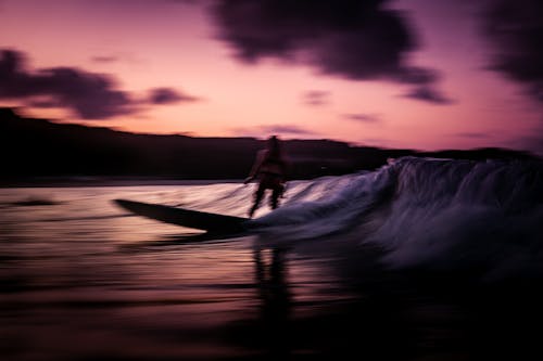 Free Woman Surfing during Sunset Stock Photo