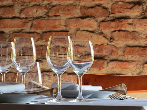 Free Glasses and Tableware on Table in Restaurant Stock Photo