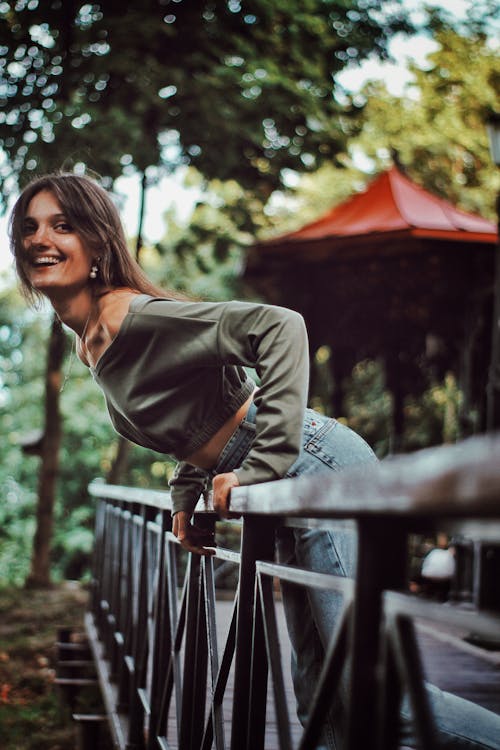 Smiling Woman Resting on Handrail