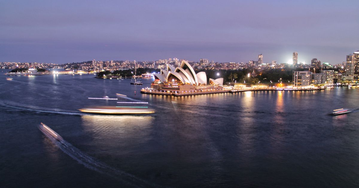 Aerial view of the Sydney Opera House, harbour ferries and the Harbour Bridge.