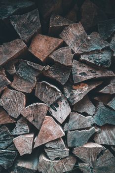 A close-up view of stacked chopped firewood, ideal for rustic decor or woodwork themes.