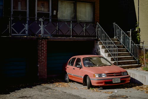 A Red Sedan Parked in the Driveway