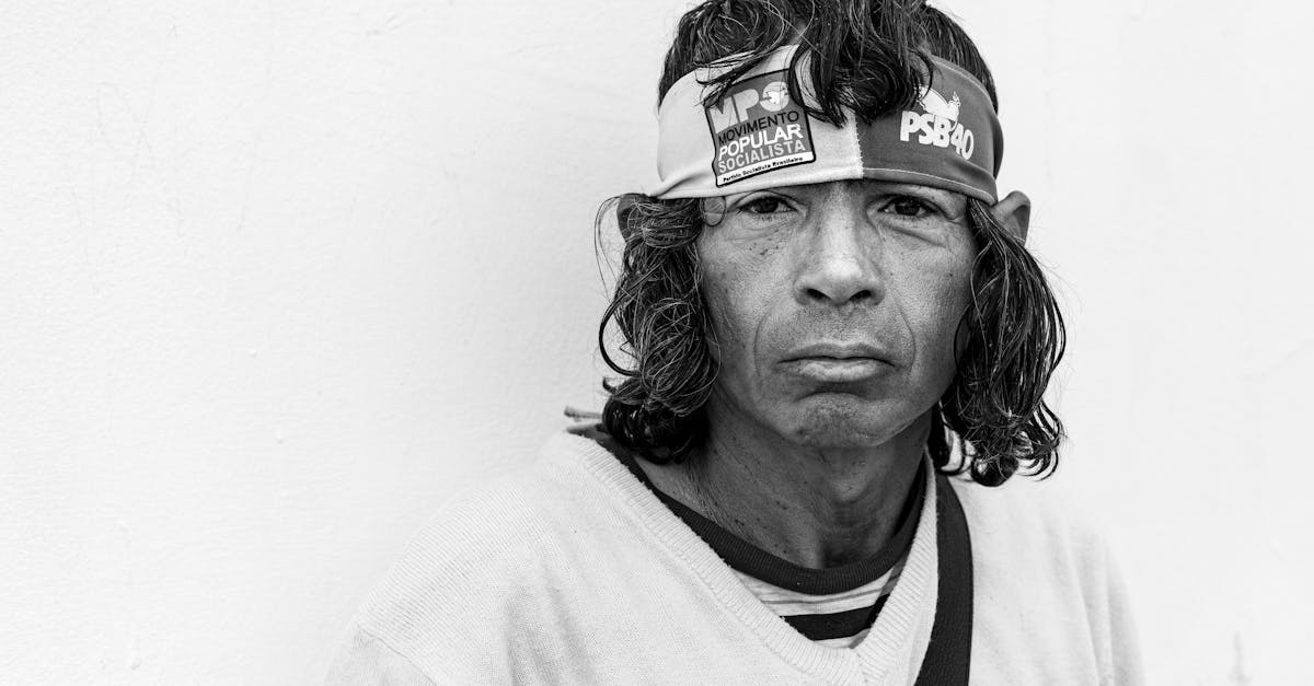 Emotive black and white portrait of a man wearing a headband, showcasing a serious expression.