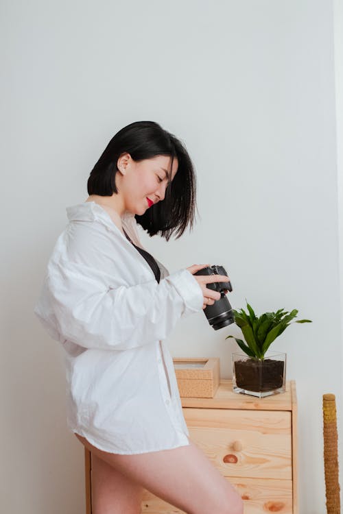 Woman Wearing White Shirt holding Camera