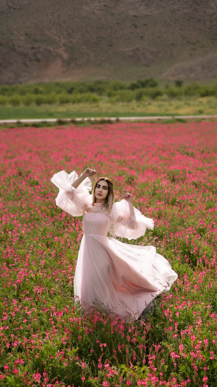 Woman In Long Dress In Flower Field