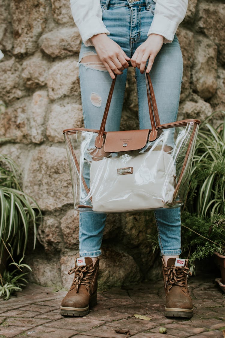 Woman In Jeans Holding Transparent Bag