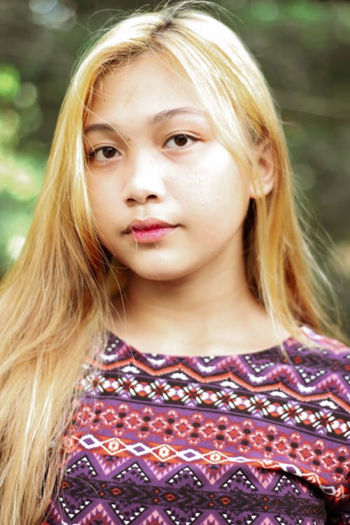 Portrait of a Woman with Blond Hair Wearing a  Purple Top