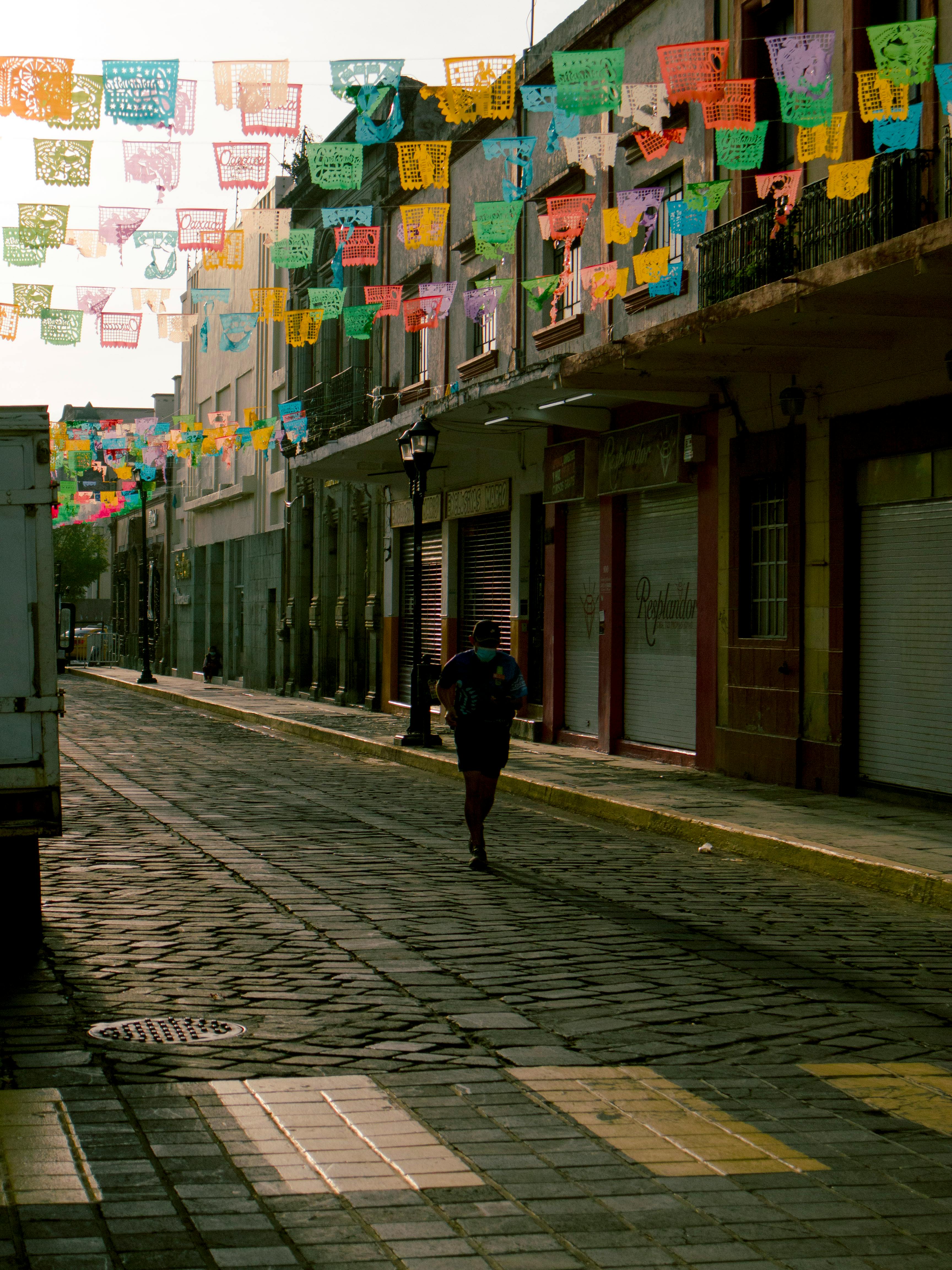 person walking on paved street