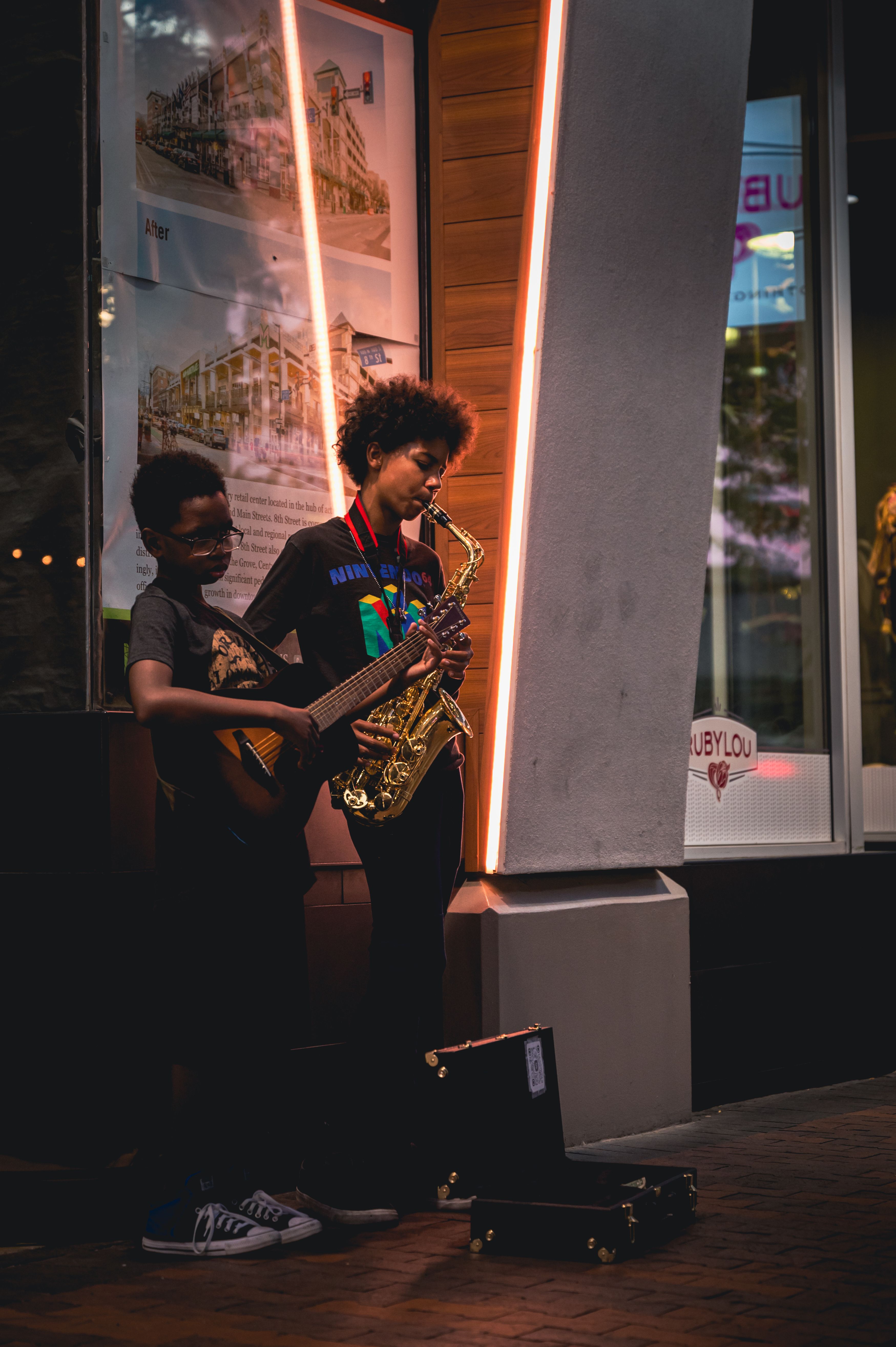 Two Boys Playing Instruments on Street · Free Stock Photo