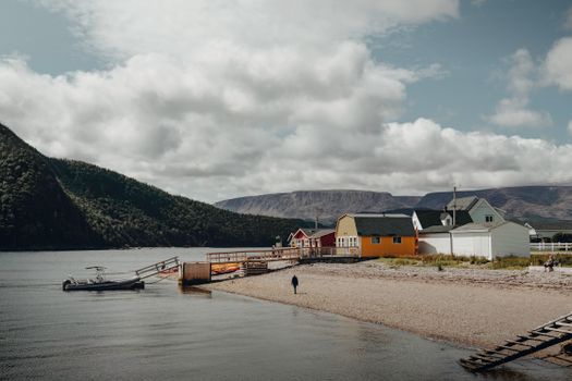 Tranquil waterfront scene with colorful houses in Norris Point, Newfoundland.