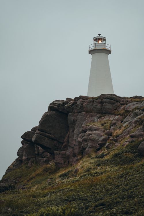Lighthouse By Rocks Lighthouse on Top of Limestone Rock Formation Overlooking Sea · Free ...