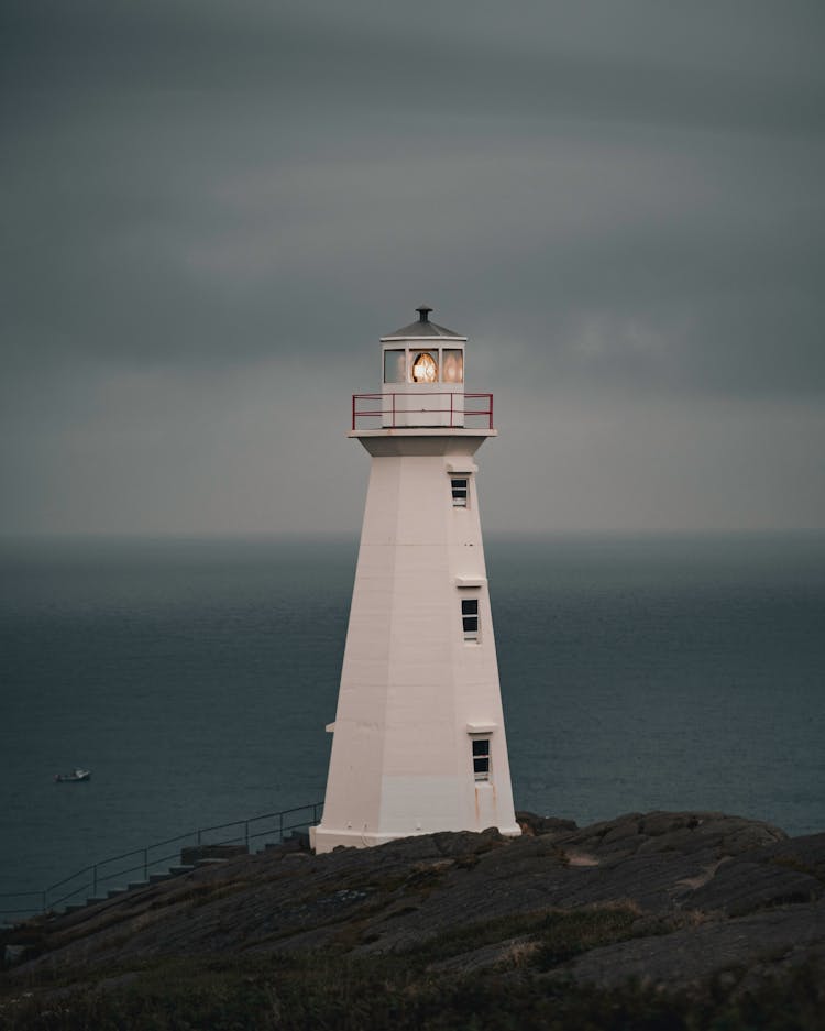 Lighthouse On Top Of Limestone Rock Formation Overlooking Sea