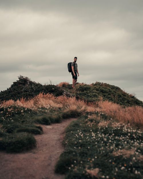 Free Man hiking on a scenic trail at Chance Cove, Newfoundland. Adventure outdoor exploration. Stock Photo