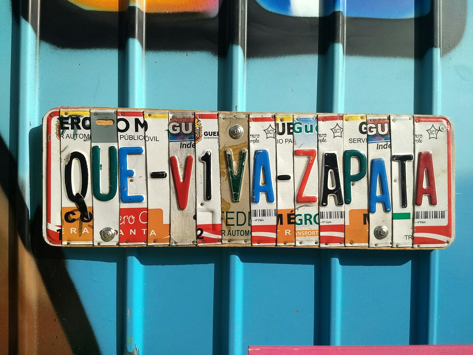 Creative license plate design featuring vibrant colors and typography saying 'Que Viva Zapata'.