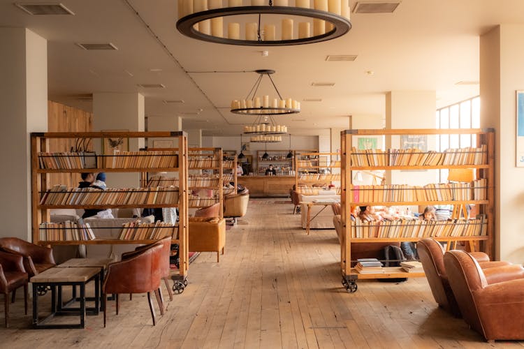 Hotel Lobby With Mobile Bookshelves And Leather Chairs