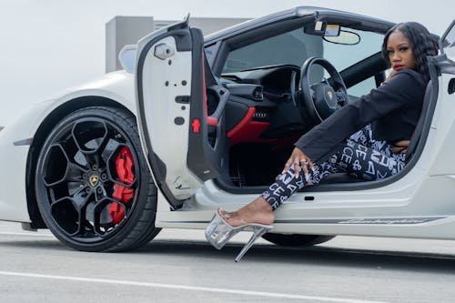 A Woman Getting Out of a Lamborghini