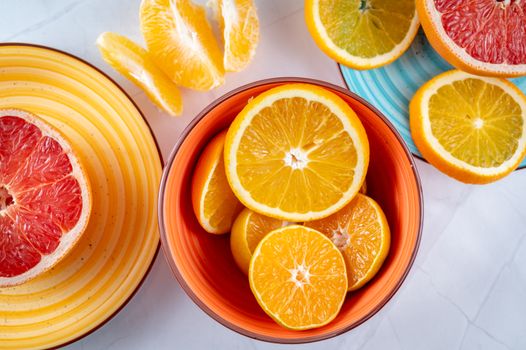 Citrus slices creatively arranged in ceramic bowls, showcasing a vivid and fresh presentation of grapefruits and oranges.