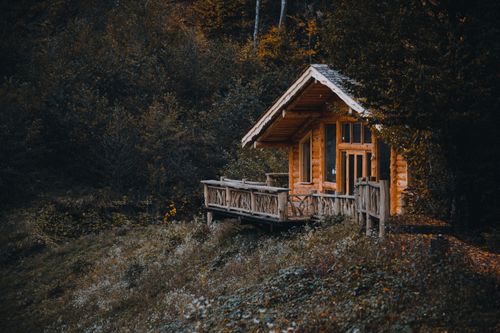 Free Charming wooden cabin nestled in autumnal forest setting in Krasnaya Polyana, perfect for nature retreats. Stock Photo