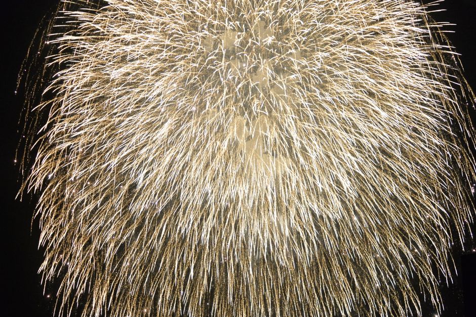 Close-up view of a dazzling fireworks explosion lighting up the night sky.