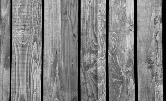 Detailed black and white texture of wooden planks showcasing natural patterns.