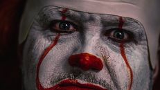 Person With Red and White Face Paint