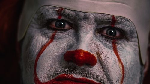 Free Intense close-up of a clown face with detailed horror makeup, perfect for Halloween themes. Stock Photo